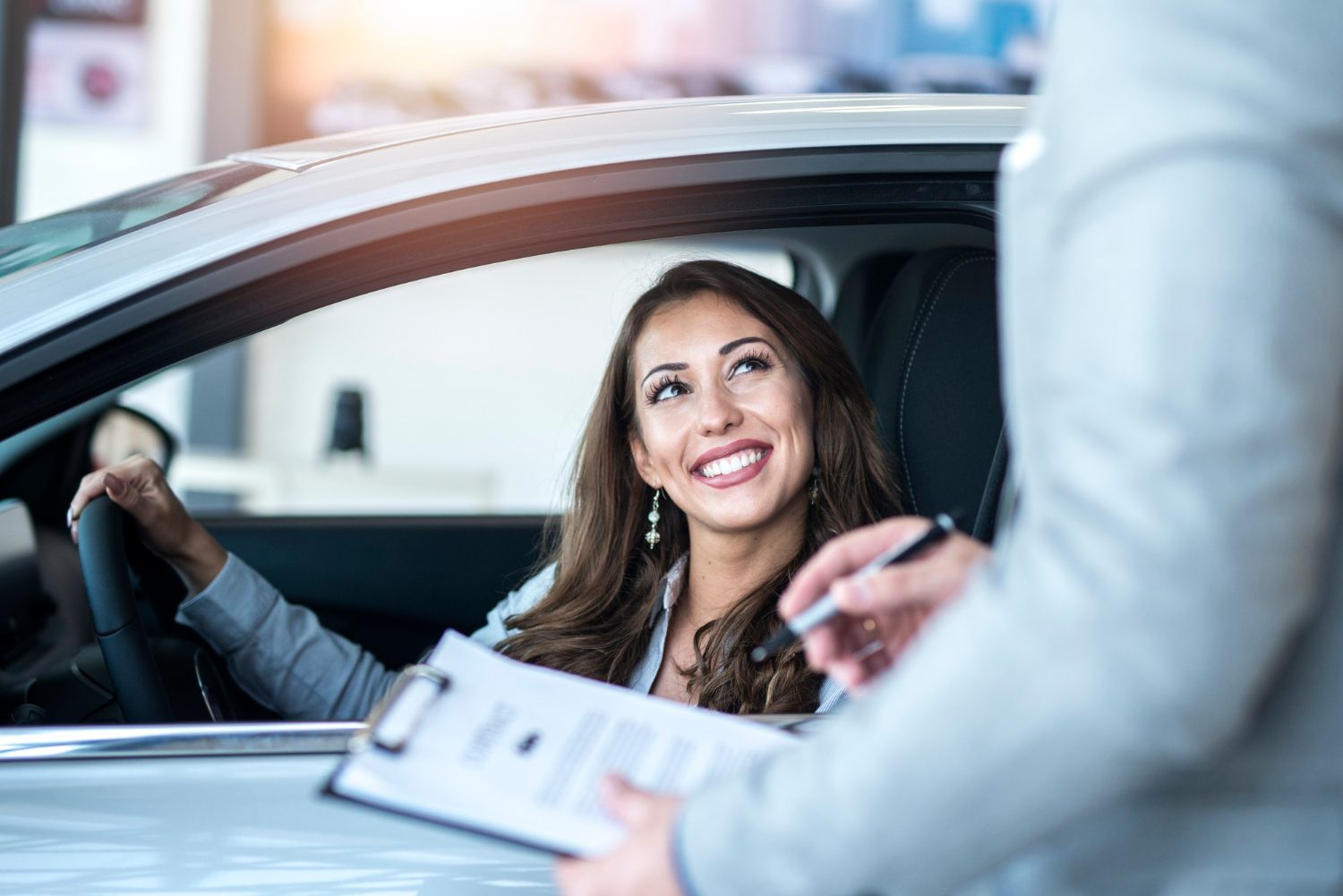 Smiling woman in her new car