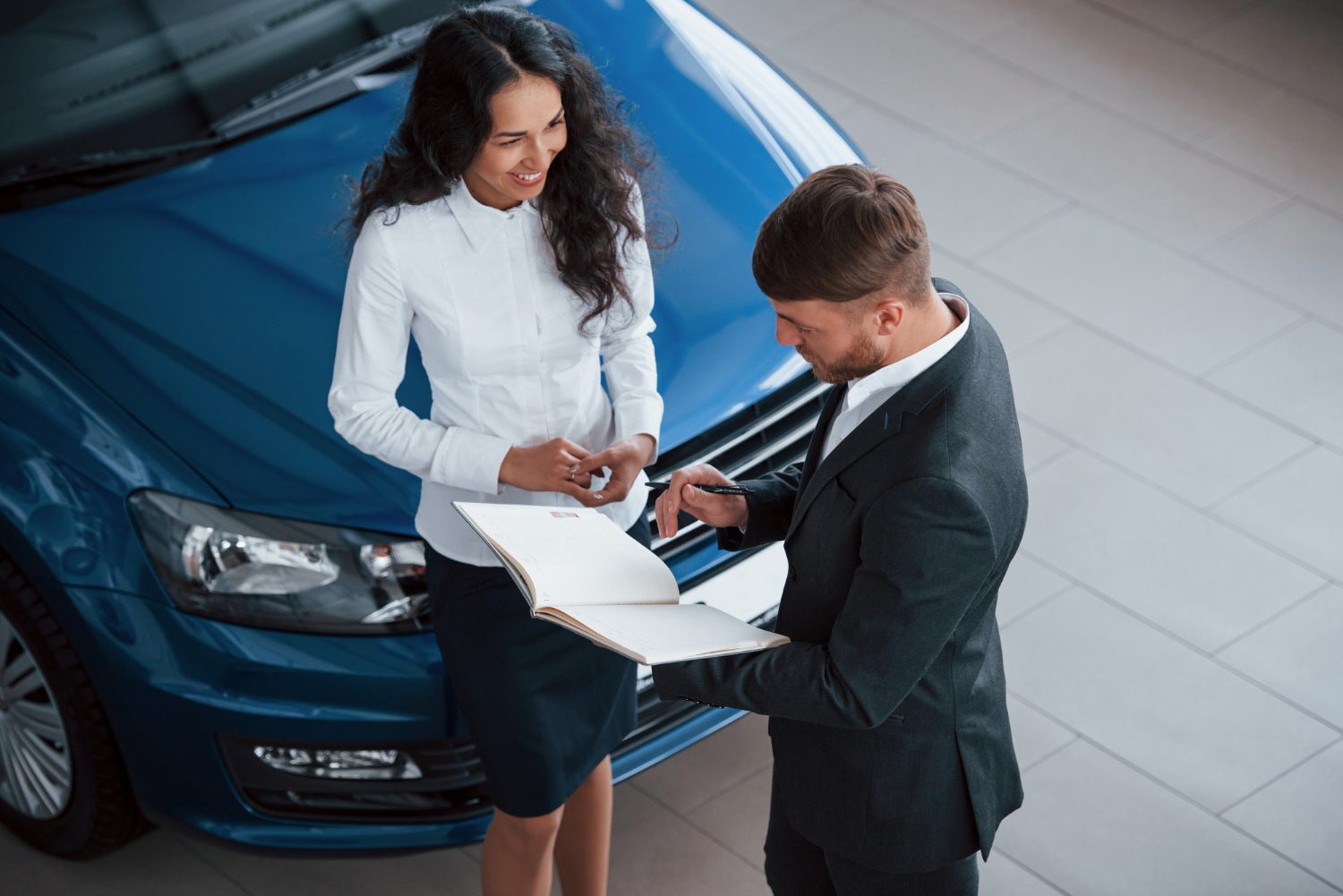 Couple finalising a car purchase