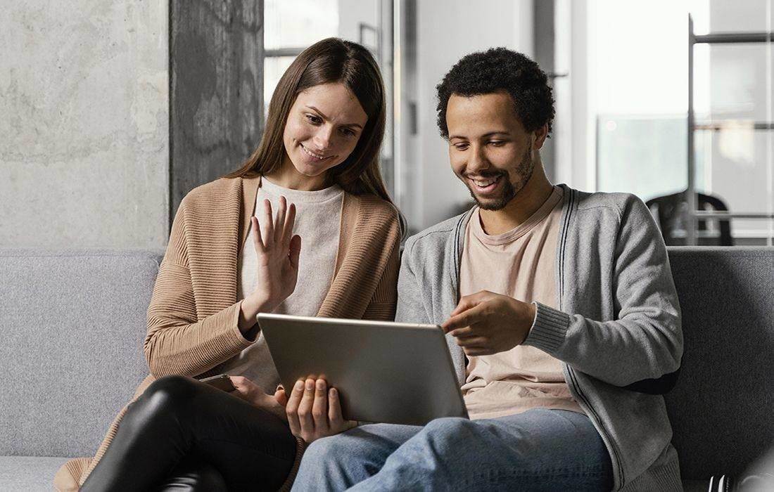 Couple managing their cash flow on a laptop