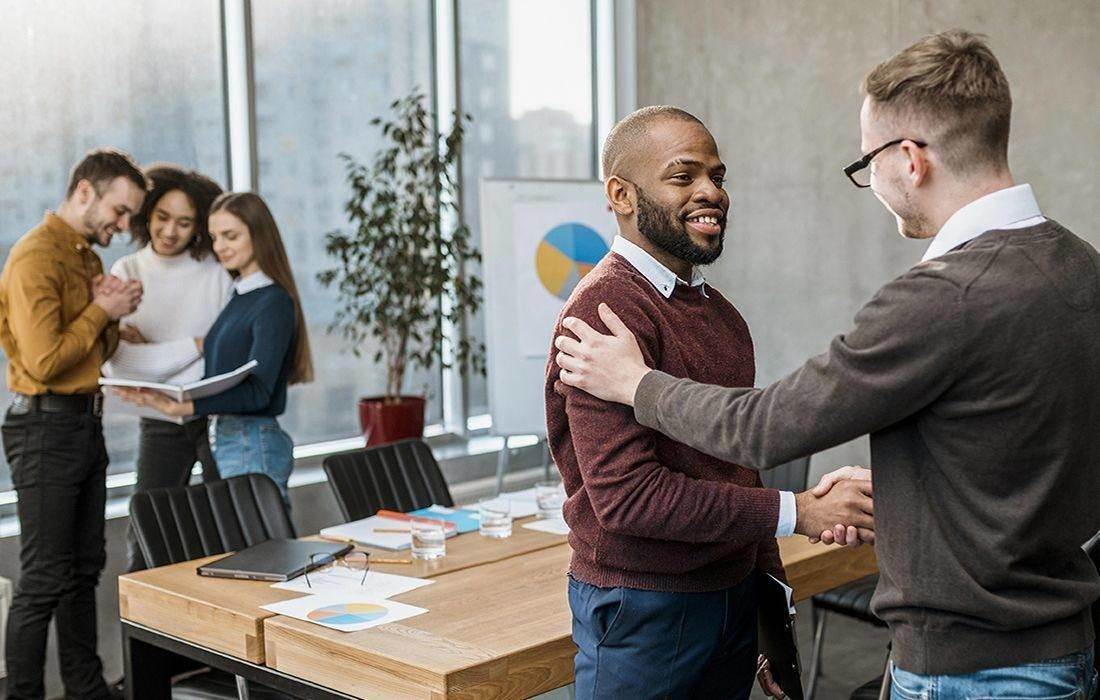 Business partners shaking hands in an office